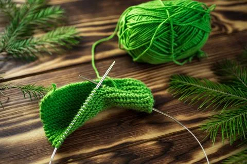 Started knitting on knitting needles, with yarn on a rustic wooden table, with Stock Photos