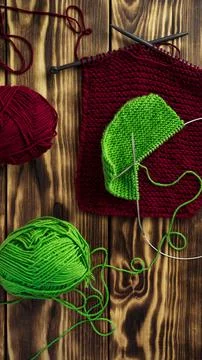 Started knitting on knitting needles, with yarn on a rustic wooden table, with Stock Photos