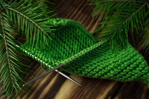 Started knitting on knitting needles, with yarn on a rustic wooden table, with Stock Photos
