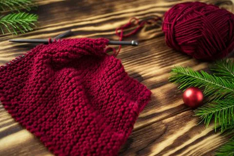 Started knitting on knitting needles, with yarn on a rustic wooden table, with Stock Photos