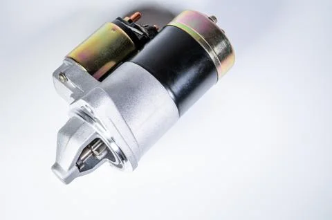 Starter of an internal combustion engine New Spare part for car on a gray Fotos de archivo