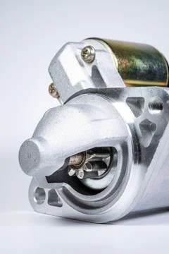 Starter of an internal combustion engine New Spare part for car on a gray Fotos de archivo