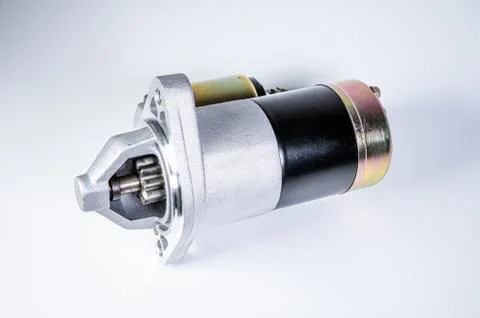 Starter of an internal combustion engine New Spare part for car on a gray Fotos de archivo