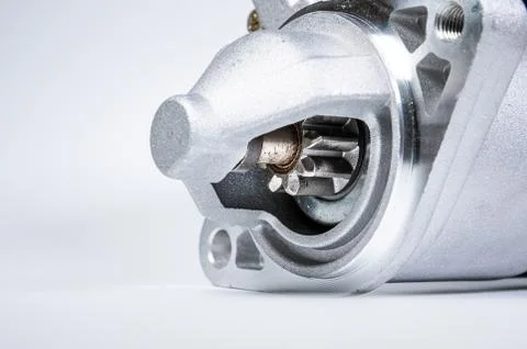 Starter of an internal combustion engine New Spare part for car on a gray Fotos de archivo