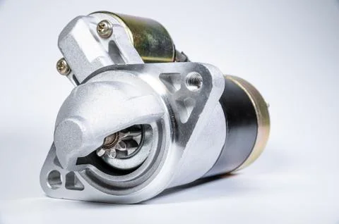 Starter of an internal combustion engine New Spare part for car on a gray Fotos de archivo