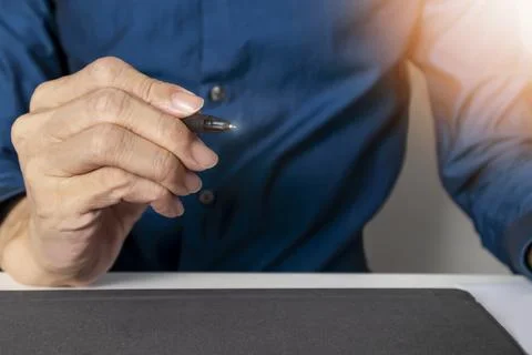 Starting business, capturing key points in mind. ,Businessman grabbing pen .. Stock Photos