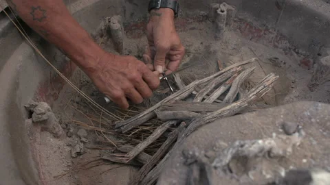Starting a camp fire sequence with a flint rod and knife Stock Footage 240060431