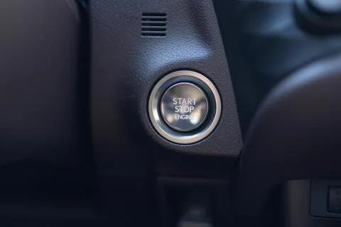 Starting car engine. Button to start the car engine. Pushing start stop ignition Foto stock