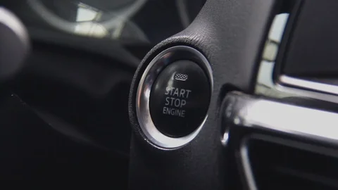Starting car engine. Track in to the button. Finger press the button to start Stock Footage 125615915