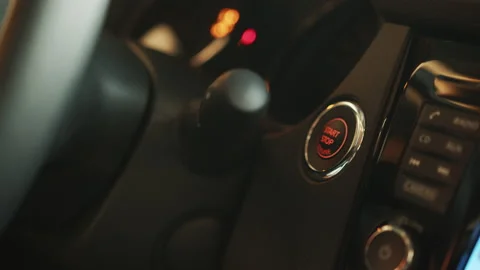 Starting car engine. Track in to the button. Finger press the button to start Stock Footage 177386230