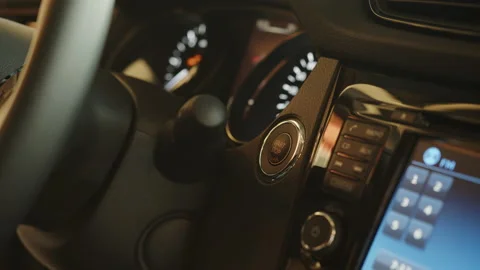 Starting car engine. Track in to the button. Finger press the button to start Stock Footage 177404290