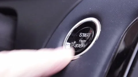 Starting car engine. Track in to the button. Finger press the button to start Stock Footage 192082469