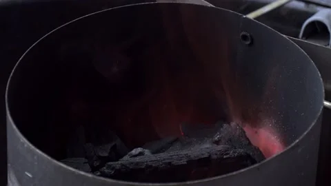 Starting a charcoal chimney Stock Footage 131249410