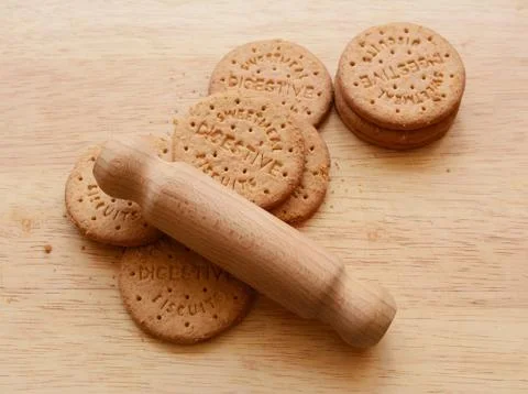 Starting to crush digestive biscuits with a rolling pin Stock Photos