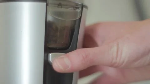 Starting electric blade coffee grinder by pushing button Stock Footage 294947223