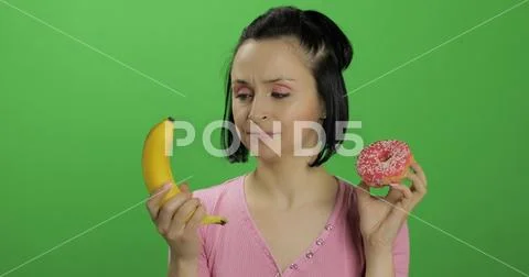 Starting healthy eating. Say no to junk food. Choice donut or banana to eat Stock Photos