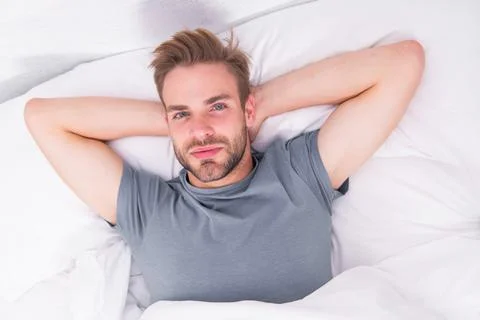 Starting his day with regular routine. Handsome guy awaken for morning routine Stock Photos