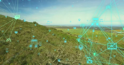 On starting network nodes emitting icons and drifting over hillside showing Stock Footage 314844823