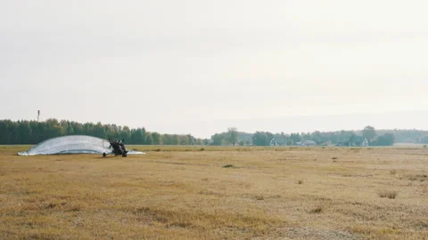 Starting paramotor gliding. Parachut lifting up and take off starts Stock Footage 137924813
