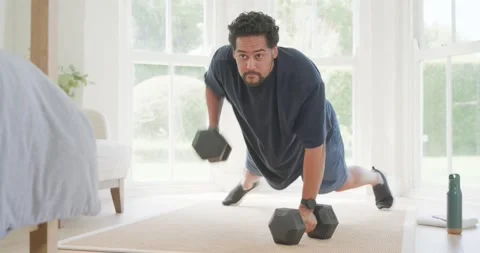 Starting plank using hex grips mid30s African American man doing pushups by Stock Footage 336306270