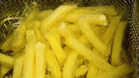 Starting process of cooking French fried potatoes in boiling oil, 4K 60 FPS Stock Footage 76952541