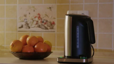 Starting process of making hot drink person activates electric kettle Stock Footage 270957385