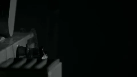 Starting up the projector in a dark room. Stock Footage 70833760