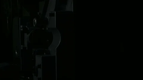 Starting up the projector in a dark room Stock Footage 70836764