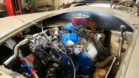Starting a race car engine in a shop Видео 63350511