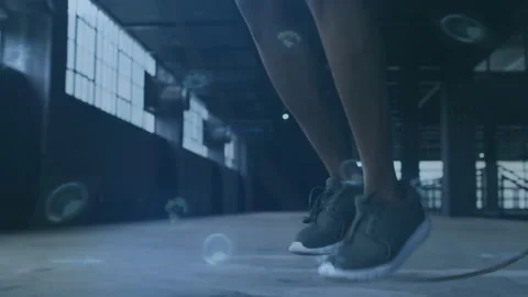 Starting rope swing, athlete performing jump-rope training in industrial hall, Stock Footage 331571215
