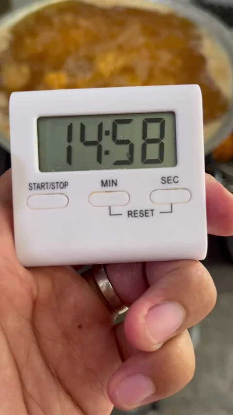 Starting a Timer for Baking a Dish in a Kitchen Setting Stock Footage 333306283