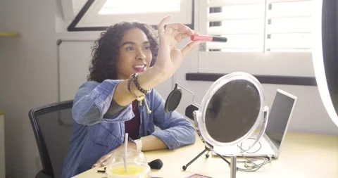 Starting tutorial non-binary creator greeting camera at studio showcasing lip Stock Footage 334923270