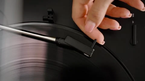 Starting the vinyl player by manual adjusting the tonearm with needle Stock Footage 302420101