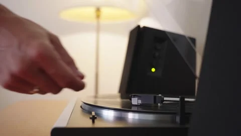 Starting the vinyl player by manual adjusting the tonearm with stylus. Stock Footage 302491981