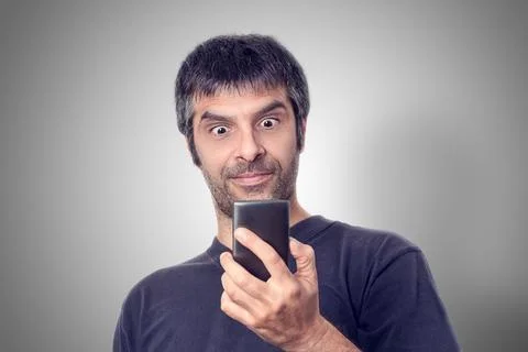 Startling Technology: Portrait of a Middle-Aged Man Astonished by his phone Foto stock