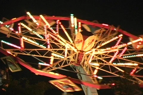Startrooper carnival ride at night, lighted Stock Footage 565749