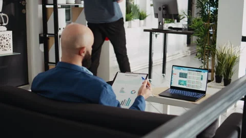 Startup analyst comparing files Stock Footage 245184575