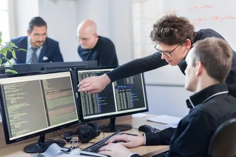 Startup business problem solving. Software developers working on desktop Foto stock
