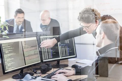 Startup business problem solving. Software developers working on desktop Foto stock
