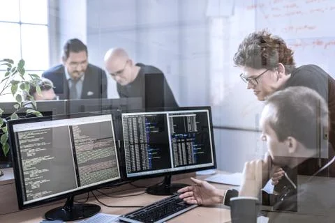 Startup business problem solving. Software developers working on desktop Stock Photos