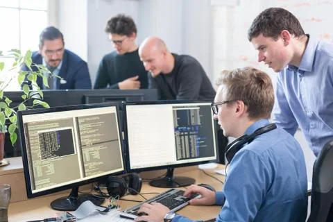 Startup business problem solving. Software developers working on desktop Foto stock
