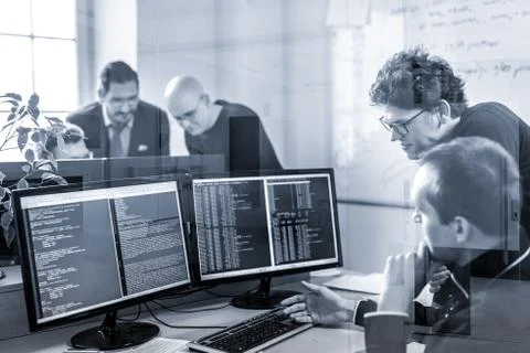 Startup business problem solving. Software developers working on desktop Stock Photos