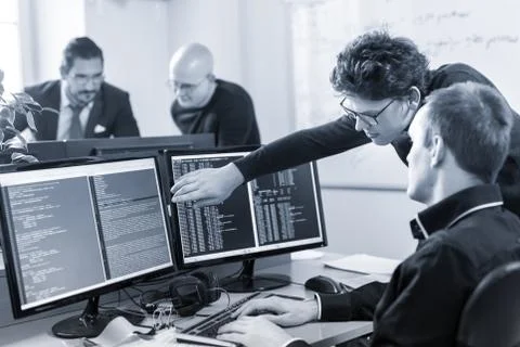 Startup business problem solving. Software developers working on desktop Stock Photos