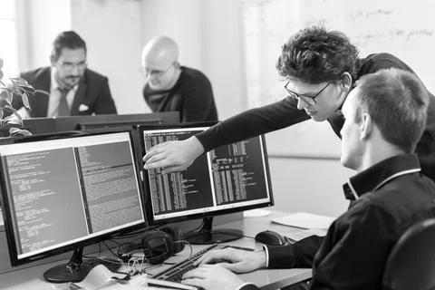 Startup business problem solving. Software developers working on desktop Foto stock