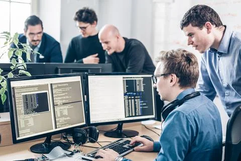 Startup business problem solving. Software developers working on desktop Stock Photos