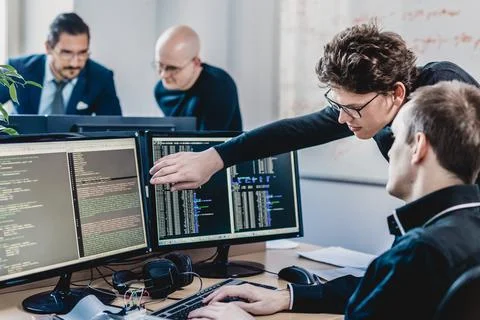 Startup business problem solving. Software developers working on desktop Foto stock