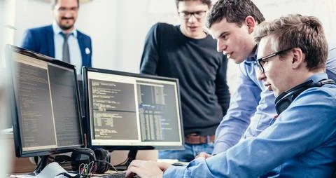 Startup business problem solving. Software developers working on desktop Foto stock
