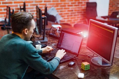 Startup business. Software developer male working on a computer at modern  Stock Photos