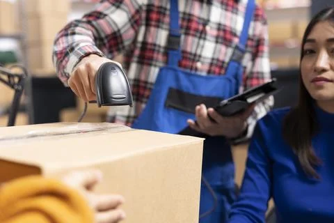 Startup employees processing orders with bar codes and invoices in supply room Stock Photos
