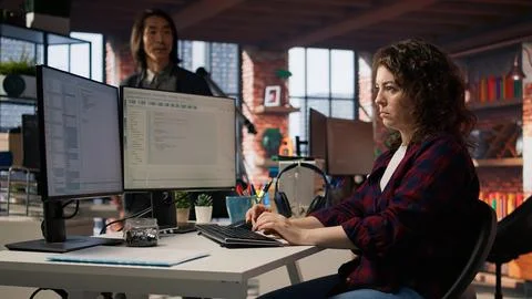 Startup engineer conducting detailed code review to fix bugs Stock Photos